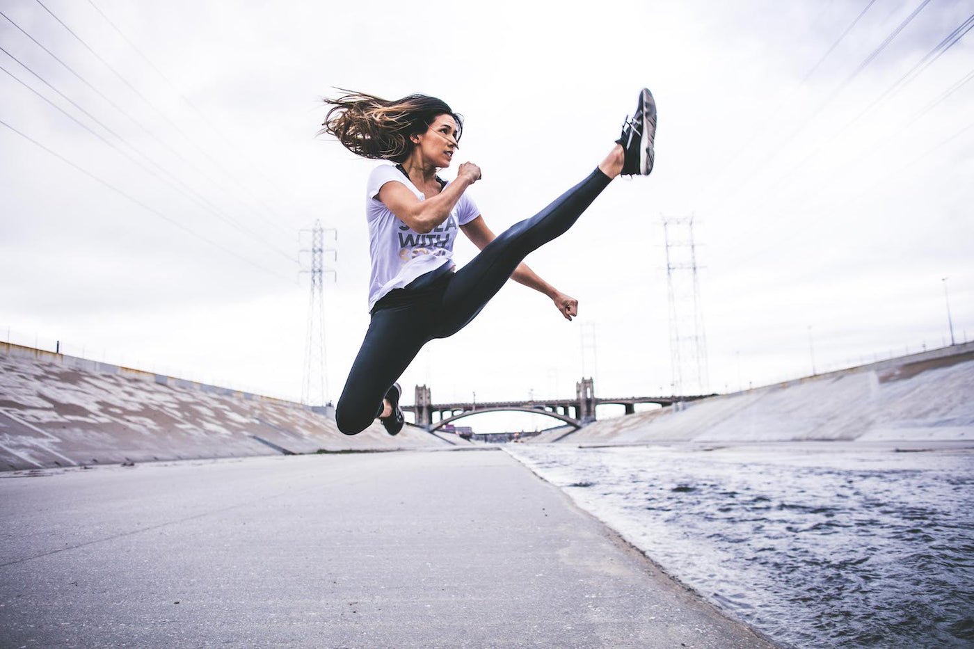 female martial artist kicking in air like a badass